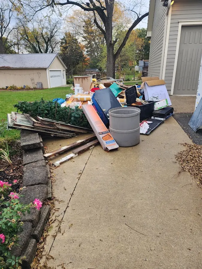 Dumpster being loaded with debris for Commercial Dumpster Rental in Mayfield